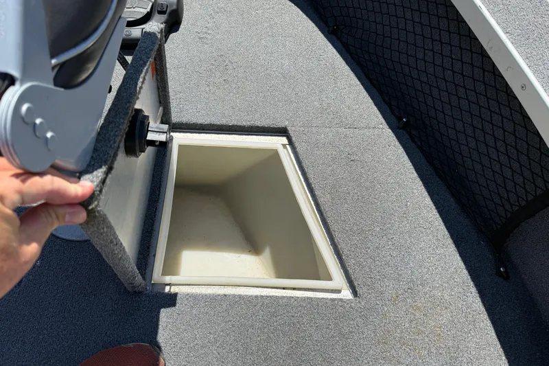 Slide: The Image of 1999 Alumacraft Tournament Pro 175 CS boat storage compartment with open lid. - 16
