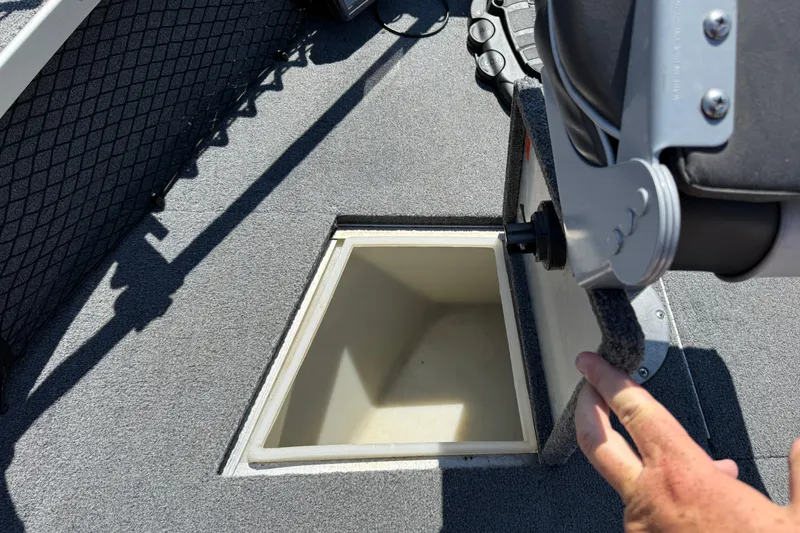 Slide: The Image of 1999 Alumacraft Tournament Pro 175 CS boat interior with open storage compartment. - 17