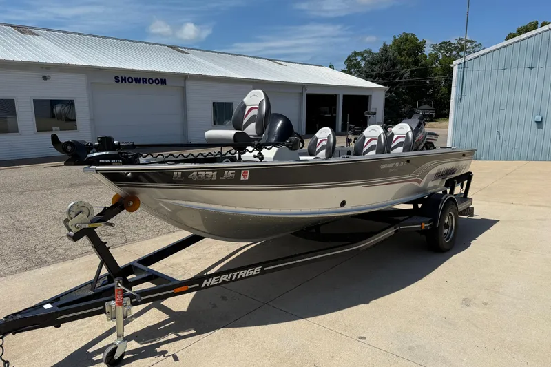 Slide: The Image of 1999 Alumacraft Tournament Pro 175 CS boat on trailer outside showroom. - 2