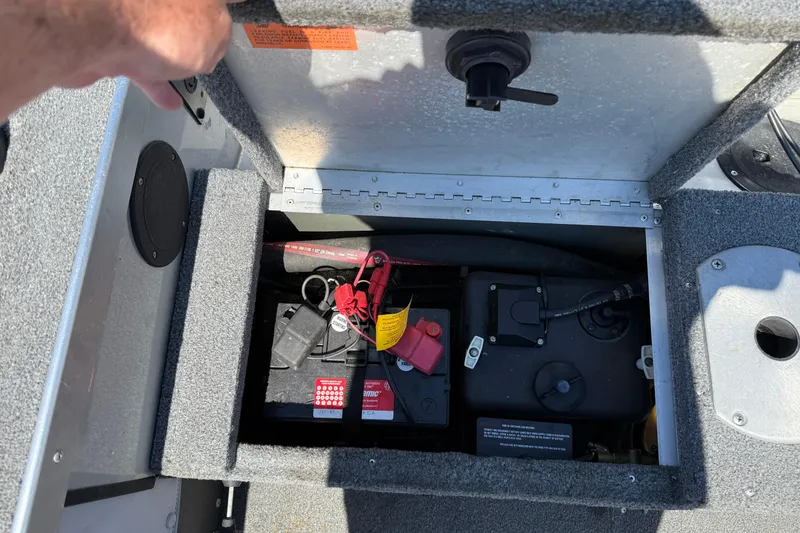 Slide: The Image of 1999 Alumacraft Tournament Pro 175 CS boat battery compartment with wiring and components. - 23