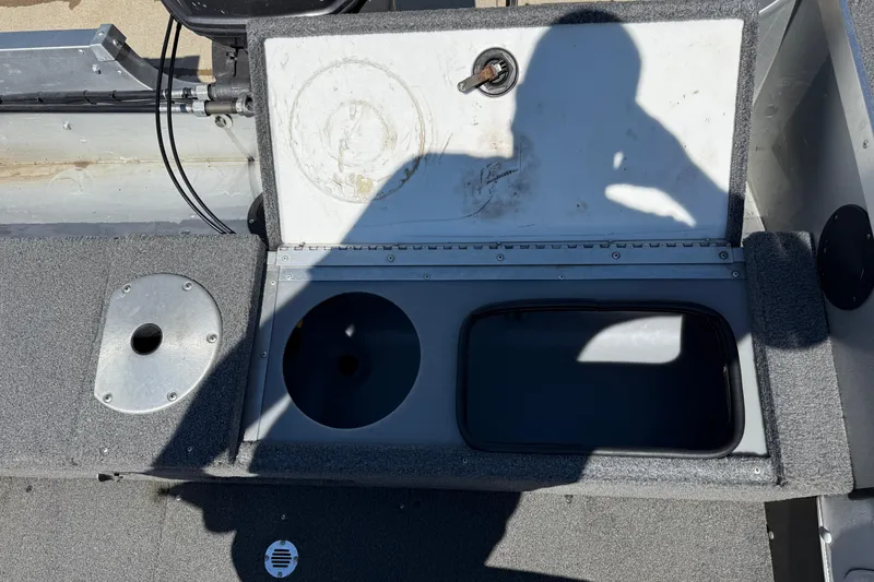 Slide: The Image of 1999 Alumacraft Tournament Pro 175 CS boat interior with open storage compartments. - 24