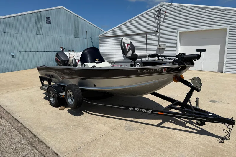 Slide: The Image of 1999 Alumacraft Tournament Pro 175 CS boat on trailer, parked outside industrial building. - 3