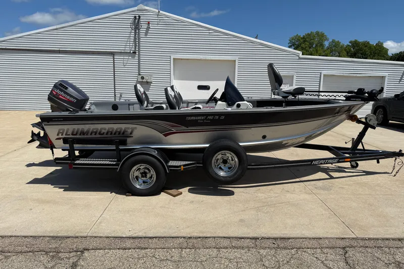 Slide: The Image of 1999 Alumacraft Tournament Pro 175 CS fishing boat on trailer, parked outdoors. - 4