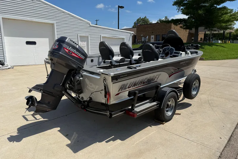 Slide: The Image of 1999 Alumacraft Tournament Pro 175 CS boat with Johnson outboard motor on trailer. - 5