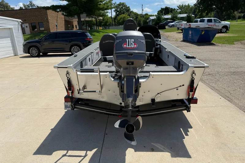 Slide: The Image of 1999 Alumacraft Tournament Pro 175 CS boat with outboard motor, parked outdoors. - 6