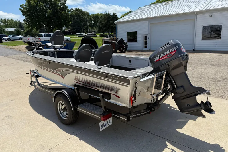 Slide: The Image of 1999 Alumacraft Tournament Pro 175 CS boat with Johnson outboard motor on trailer. - 7