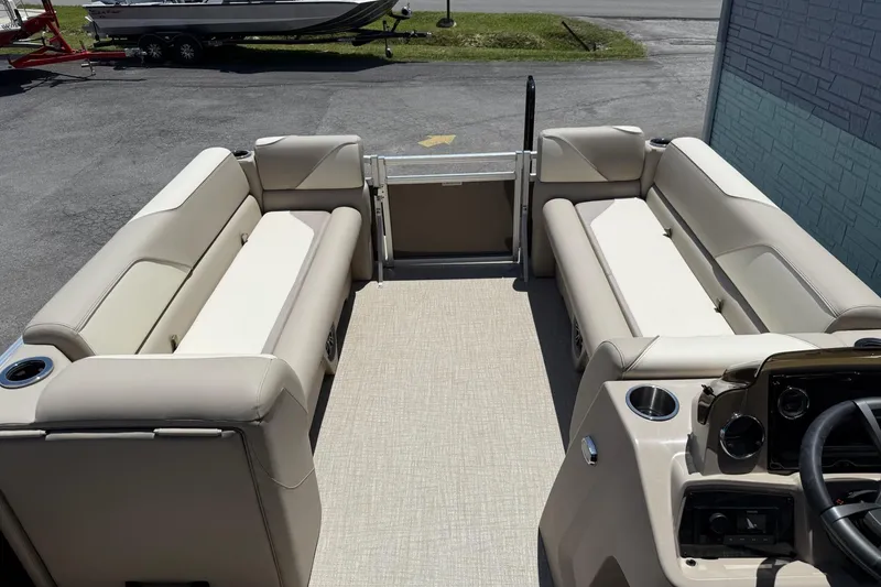 Slide: The Image of 2025 Avalon 2380 Venture Quad Lounger with beige seating and modern dashboard. - 11