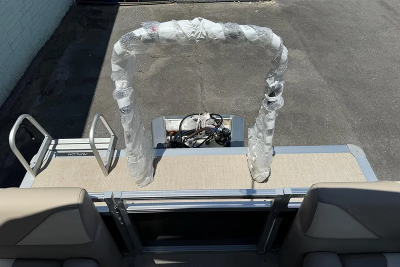 Slide: The Image of 2025 Avalon 2380 Venture Quad Lounger boat with wrapped components on deck. - 12