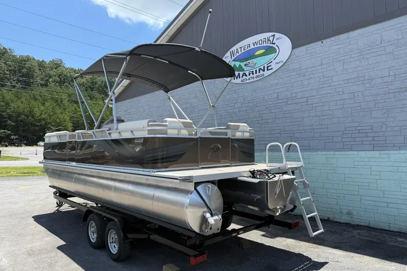 Slide: The Image of 2025 Avalon 2380 Venture Quad Lounger pontoon boat on trailer outside marine shop. - 4