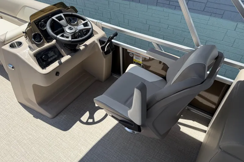 Slide: The Image of 2025 Avalon 2380 Venture Quad Lounger helm with steering wheel and captain's chair. - 7