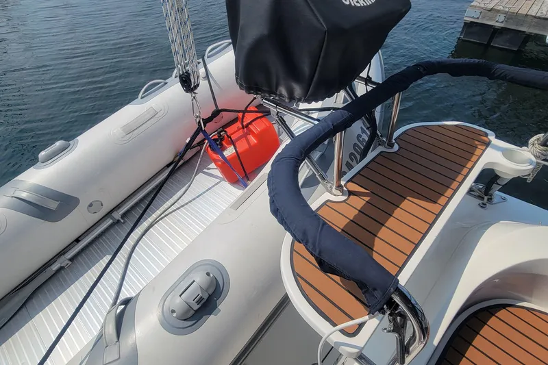 Slide: The Image of Inflatable boat on water with wooden deck, featuring a 2009 Hunter 38 model. - 11