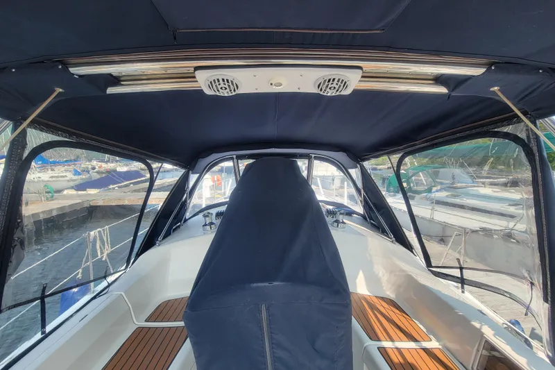 Slide: The Image of Interior view of a 2009 Hunter 38 sailboat cockpit with blue canopy. - 13