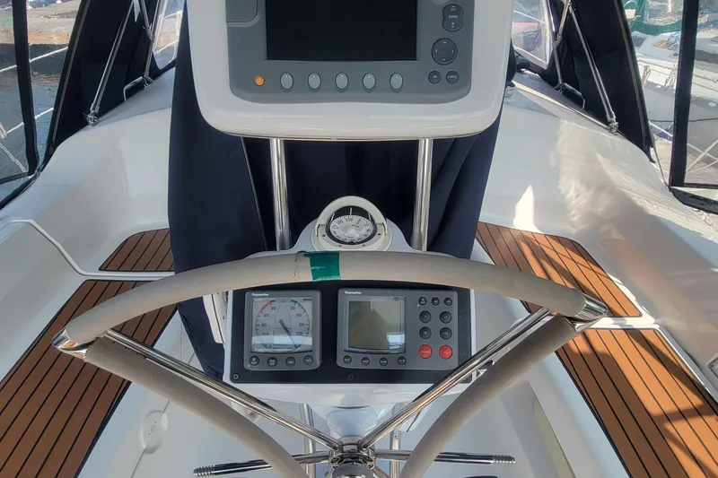Slide: The Image of Cockpit of 2009 Hunter 38 sailboat with navigation instruments and steering wheel. - 14