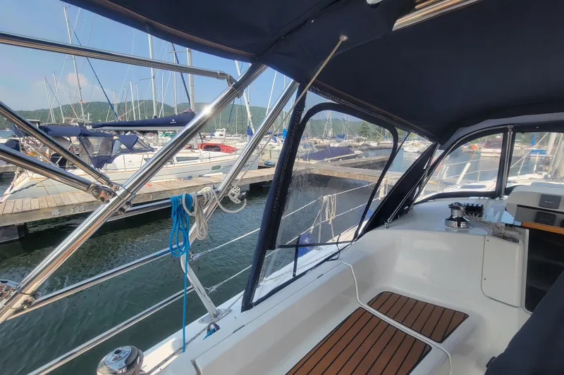 Slide: The Image of Interior view of 2009 Hunter 38 sailboat cockpit with marina background. - 16