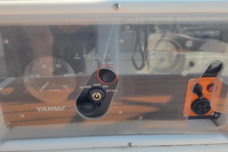 Slide: The Image of Control panel of a 2009 Hunter 38 sailboat featuring Yanmar engine gauges and switches. - 19