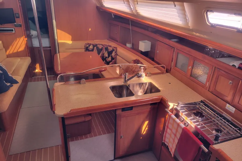Slide: The Image of Interior of a 2009 Hunter 38 sailboat with kitchen and seating area. - 20