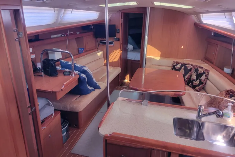 Slide: The Image of Interior of 2009 Hunter 38 sailboat with cozy seating, table, and kitchenette. - 21