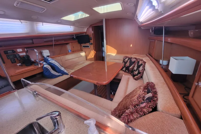 Slide: The Image of Luxurious interior of a 2009 Hunter 38 sailboat with cozy seating and elegant wood finishes. - 25