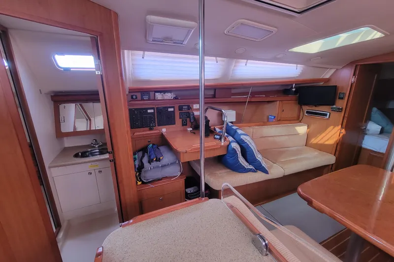 Slide: The Image of Interior of 2009 Hunter 38 sailboat with cozy seating and navigation area. - 26