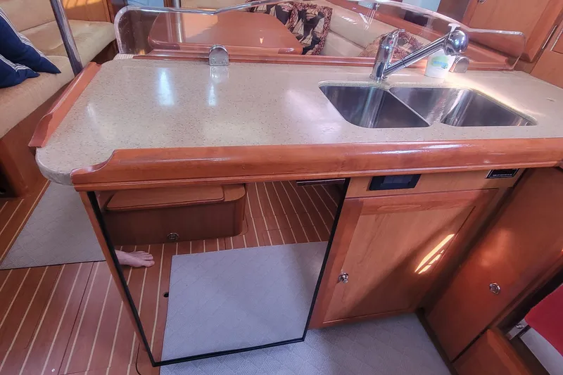 Slide: The Image of Interior of 2009 Hunter 38 yacht kitchen with dual sink and wooden cabinetry. - 29