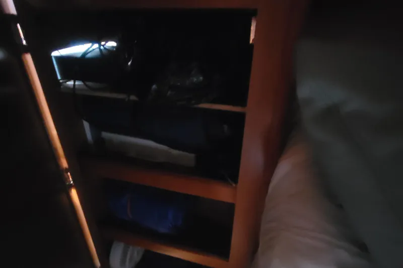 Slide: The Image of Dimly lit wooden cabinet interior on a 2009 Hunter 38 sailboat. - 32