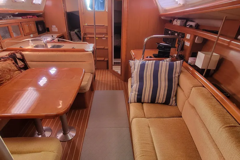Slide: The Image of Interior of 2009 Hunter 38 sailboat with cozy seating and wooden finishes. - 33