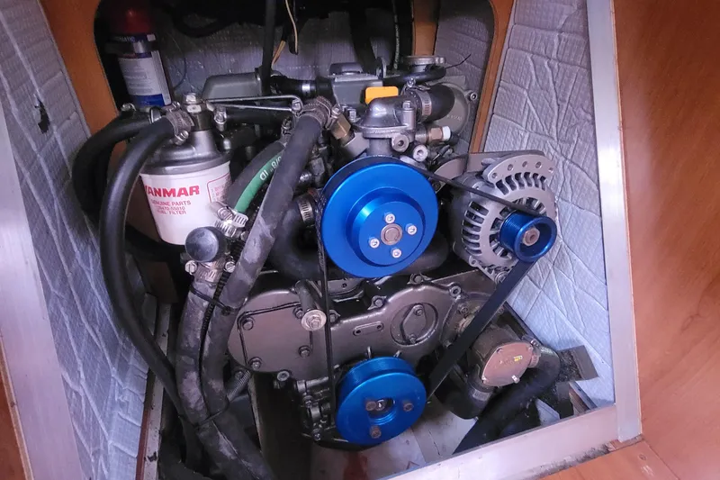 Slide: The Image of Engine compartment of a 2009 Hunter 38 sailboat, featuring a Yanmar engine. - 36