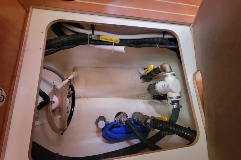 Slide: The Image of Bilge compartment of 2009 Hunter 38 sailboat with hoses and valves. - 37