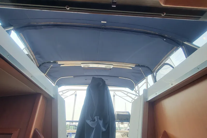 Slide: The Image of Interior view of a 2009 Hunter 38 sailboat with blue canopy and wooden accents. - 38