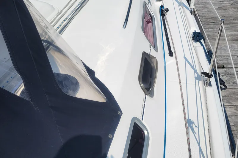 Slide: The Image of 2009 Hunter 38 sailboat deck with windows and rigging details. - 42