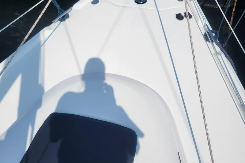 Slide: The Image of Shadow on deck of 2009 Hunter 38 sailboat, featuring ropes and seating area. - 44