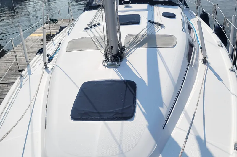 Slide: The Image of 2009 Hunter 38 sailboat deck with hatches and rigging, docked at marina. - 47