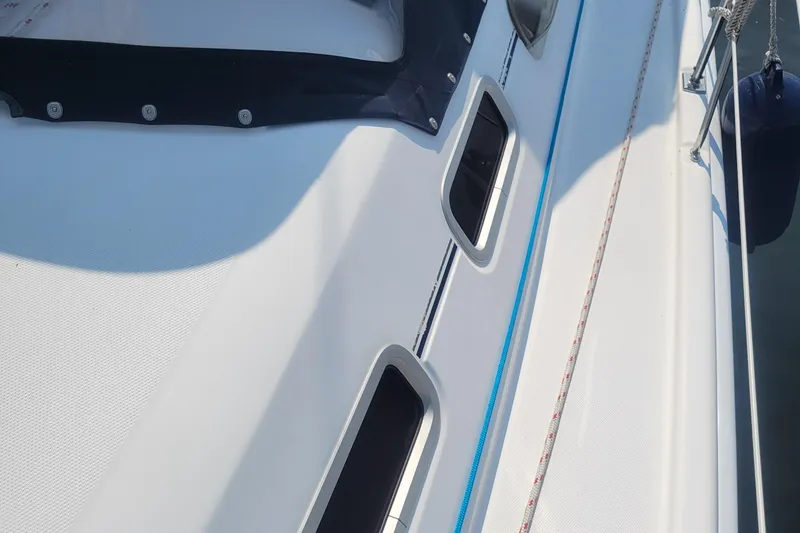 Slide: The Image of Close-up of 2009 Hunter 38 sailboat deck with windows and rigging. - 49