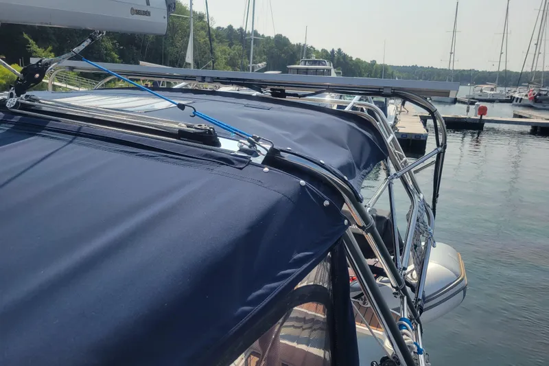 Slide: The Image of Sailboat Hunter 38 (2009) docked, featuring blue canvas and rigging details. - 50