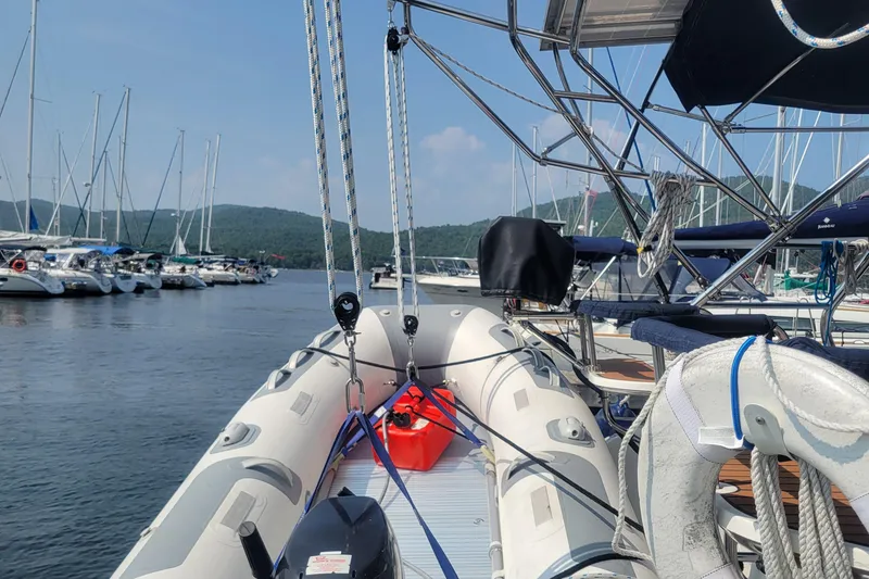 Slide: The Image of Inflatable boat on a 2009 Hunter 38 yacht, docked in a marina with sailboats. - 54