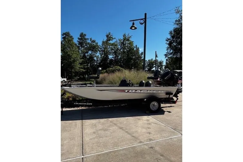 The Image of 2026 Tracker Pro 170 boat on trailer, parked outdoors under clear blue sky. - 0