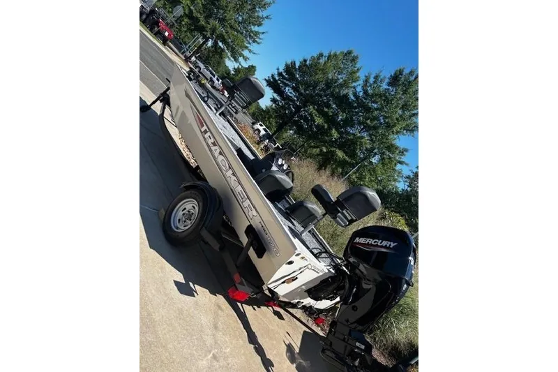 Slide: The Image of 2026 Tracker Pro 170 boat with Mercury engine on a trailer, parked outdoors. - 2