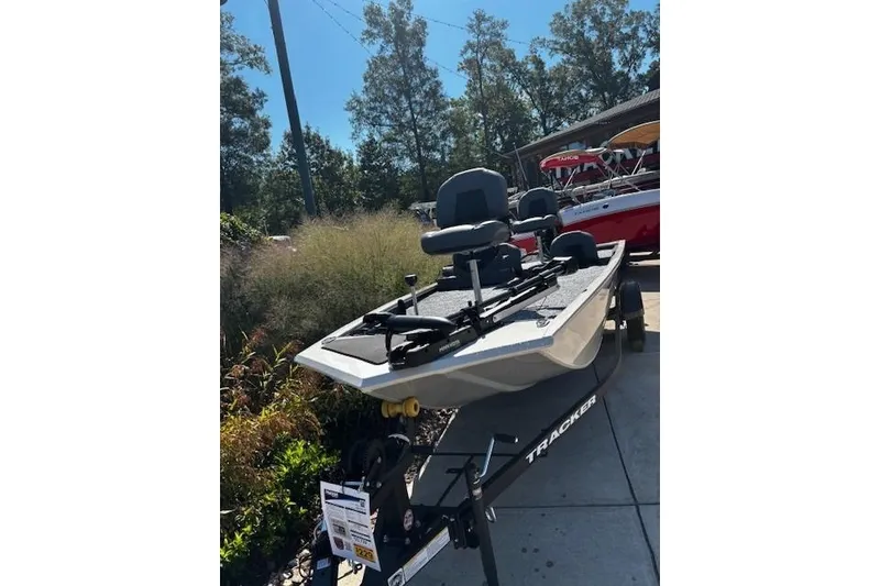 Slide: The Image of 2026 Tracker Pro 170 boat on trailer, outdoor display with trees in background. - 3