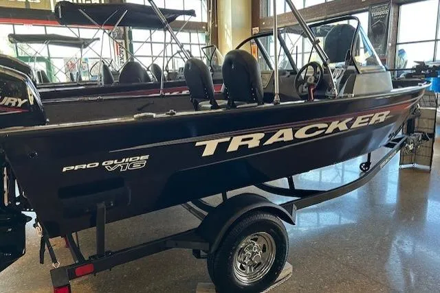 The Image of 2026 Tracker Pro Guide V-16 WT boat displayed indoors on a trailer. - 0