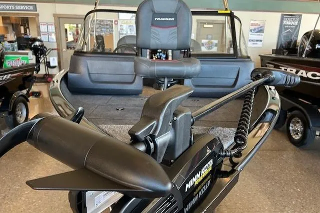 Slide: The Image of 2026 Tracker Pro Guide V-16 WT boat with Minn Kota trolling motor in showroom. - 3