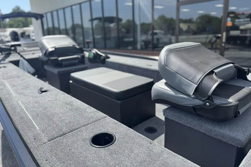 Slide: The Image of 2025 Tracker Panfish 17 boat interior with gray seating and carpeted flooring. - 3