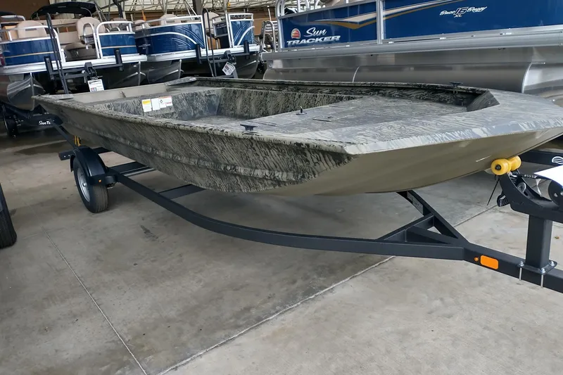 The Image of 2026 Tracker GRIZZLY 1860 Utility boat on trailer in showroom. - 0