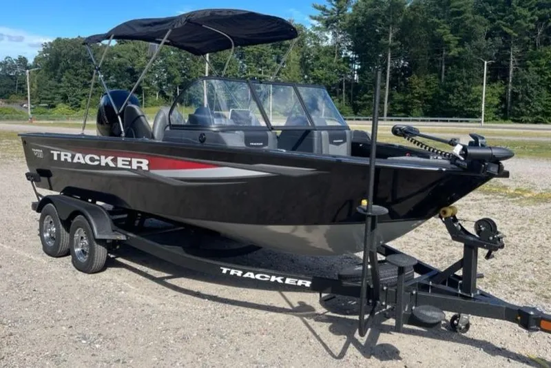 Slide: The Image of 2026 Tracker Targa V-18 WT boat on trailer, parked outdoors. - 2