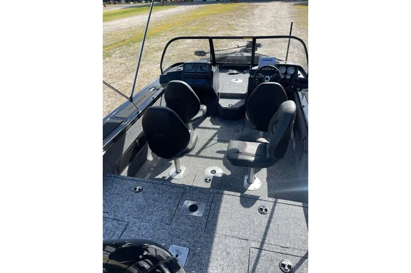 Slide: The Image of 2026 Tracker Targa V-18 WT boat interior with four seats and steering console. - 5