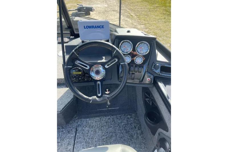 Slide: The Image of 2026 Tracker Targa V-18 WT boat dashboard with steering wheel and gauges. - 6