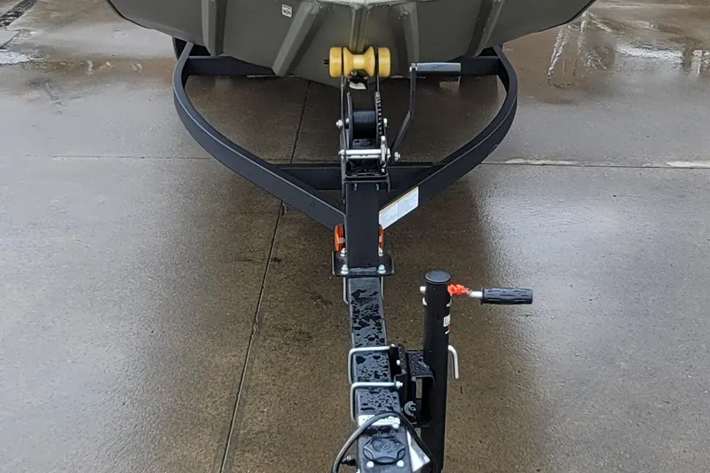 Slide: The Image of Front view of 2026 Tracker Grizzly 1654 T Sportsman trailer hitch on wet pavement. - 4