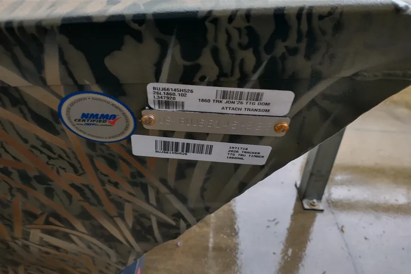 Slide: The Image of 2026 Tracker GRIZZLY 1860 Utility boat with NMMA certification label and identification tags. - 3