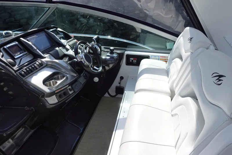 Slide: The Image of 2016 Monterey 355 Sport Yacht cockpit with modern controls and luxurious white seating. - 11