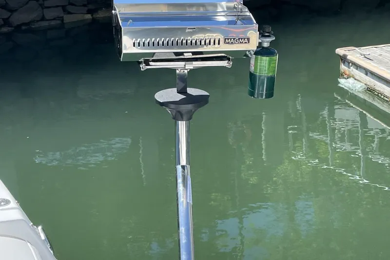 Slide: The Image of Outdoor grill mounted on a 2016 Monterey 355 Sport Yacht by the water. - 18