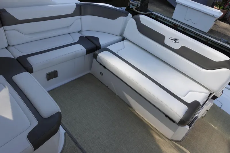Slide: The Image of Luxurious seating on a 2016 Monterey 355 Sport Yacht, featuring sleek white and gray upholstery. - 19